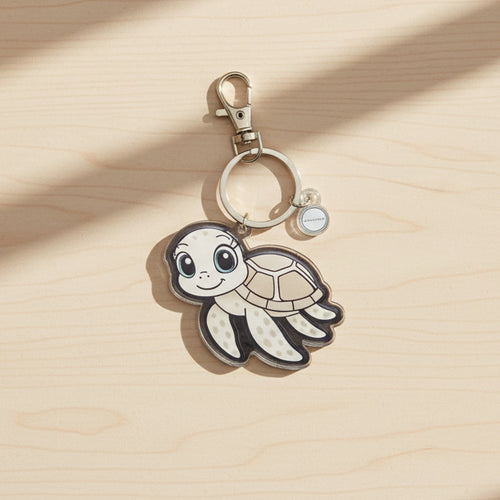 Keychain with a supportive little buddy  sea turtle design on a black background