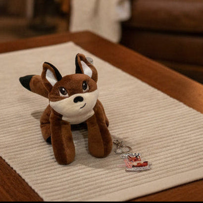 Plush fox coping tool and keychain on a home table 