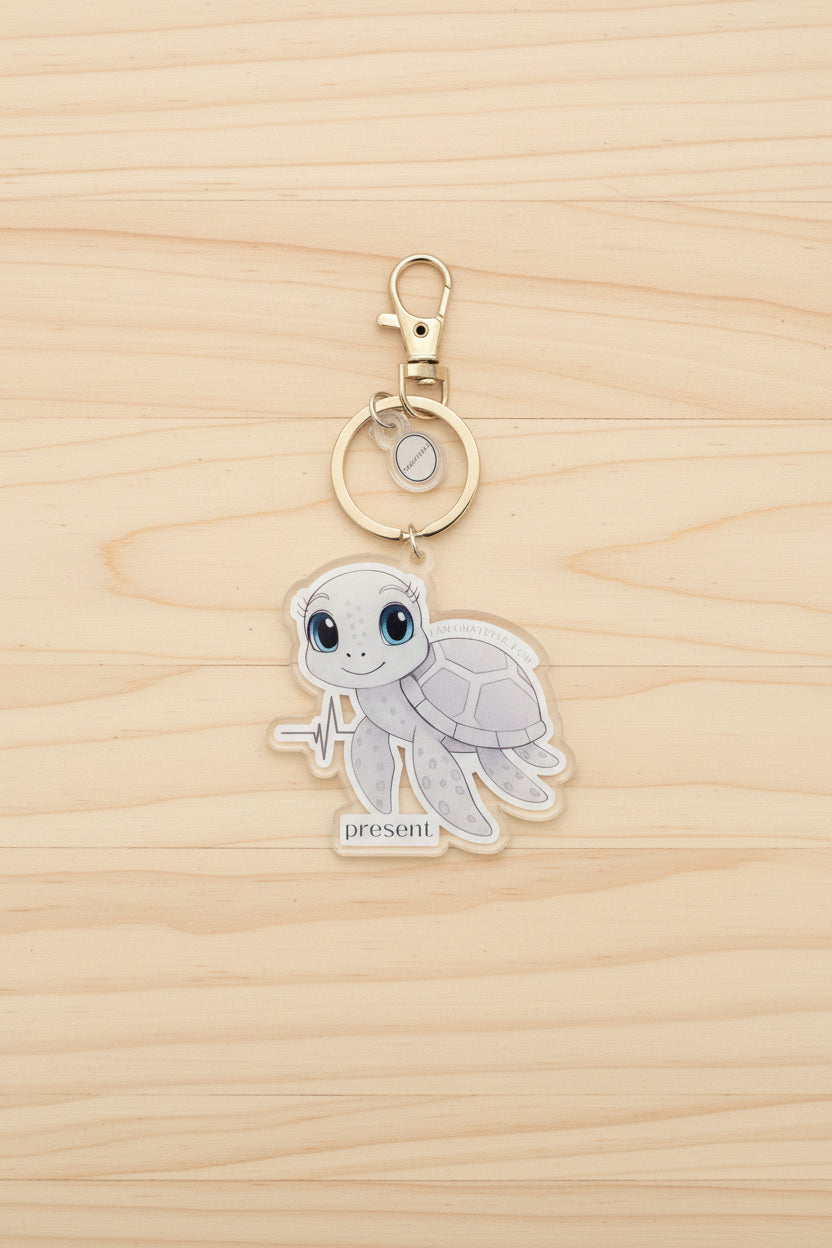 Keychain with a sea turtle design on a wood background