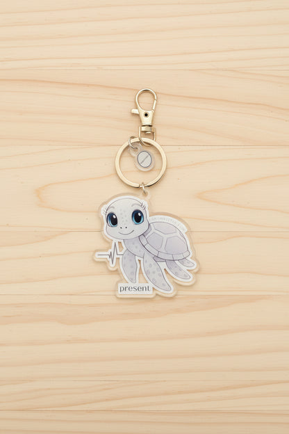 Keychain with a sea turtle design on a wood background