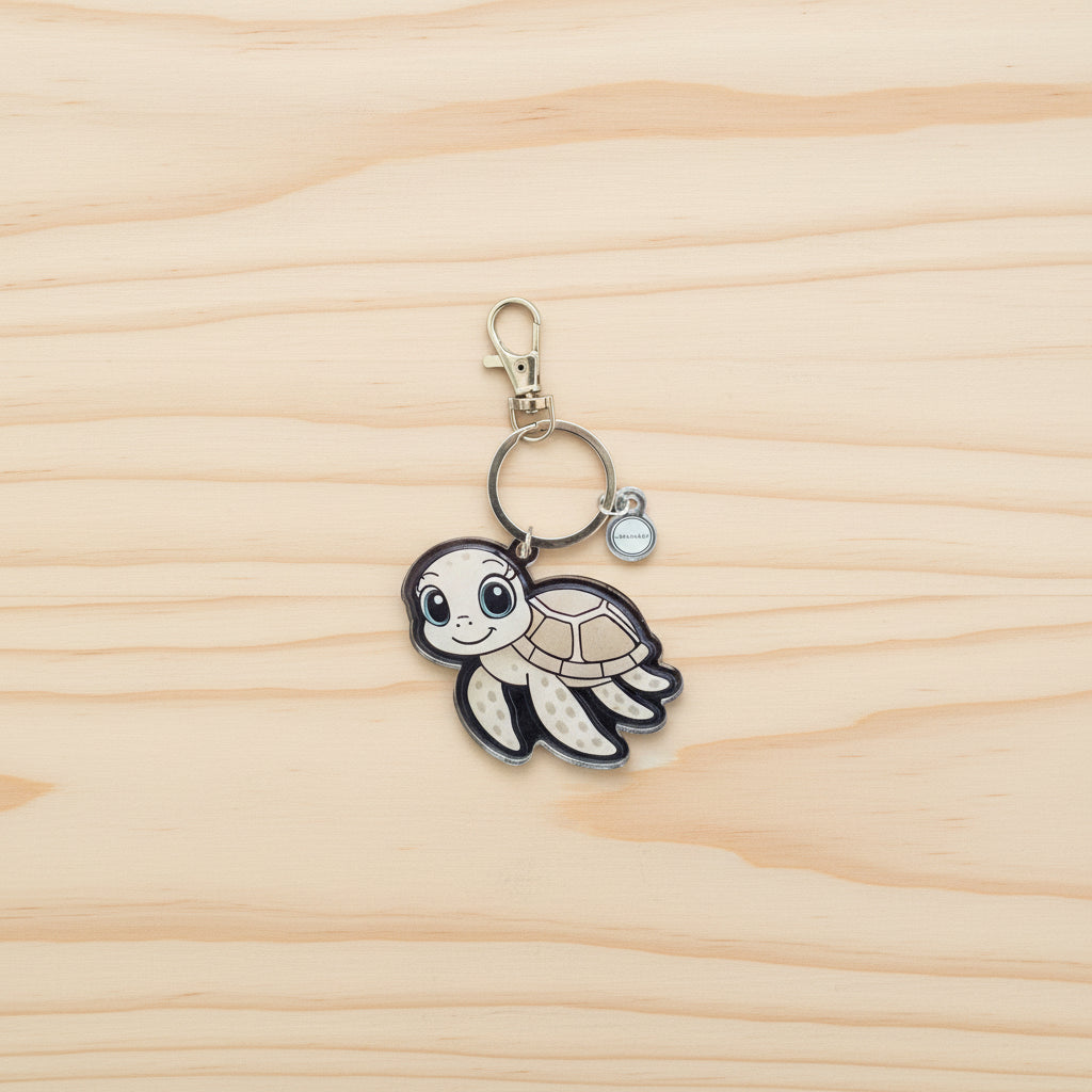 Keychain with a sea turtle design on a wood background