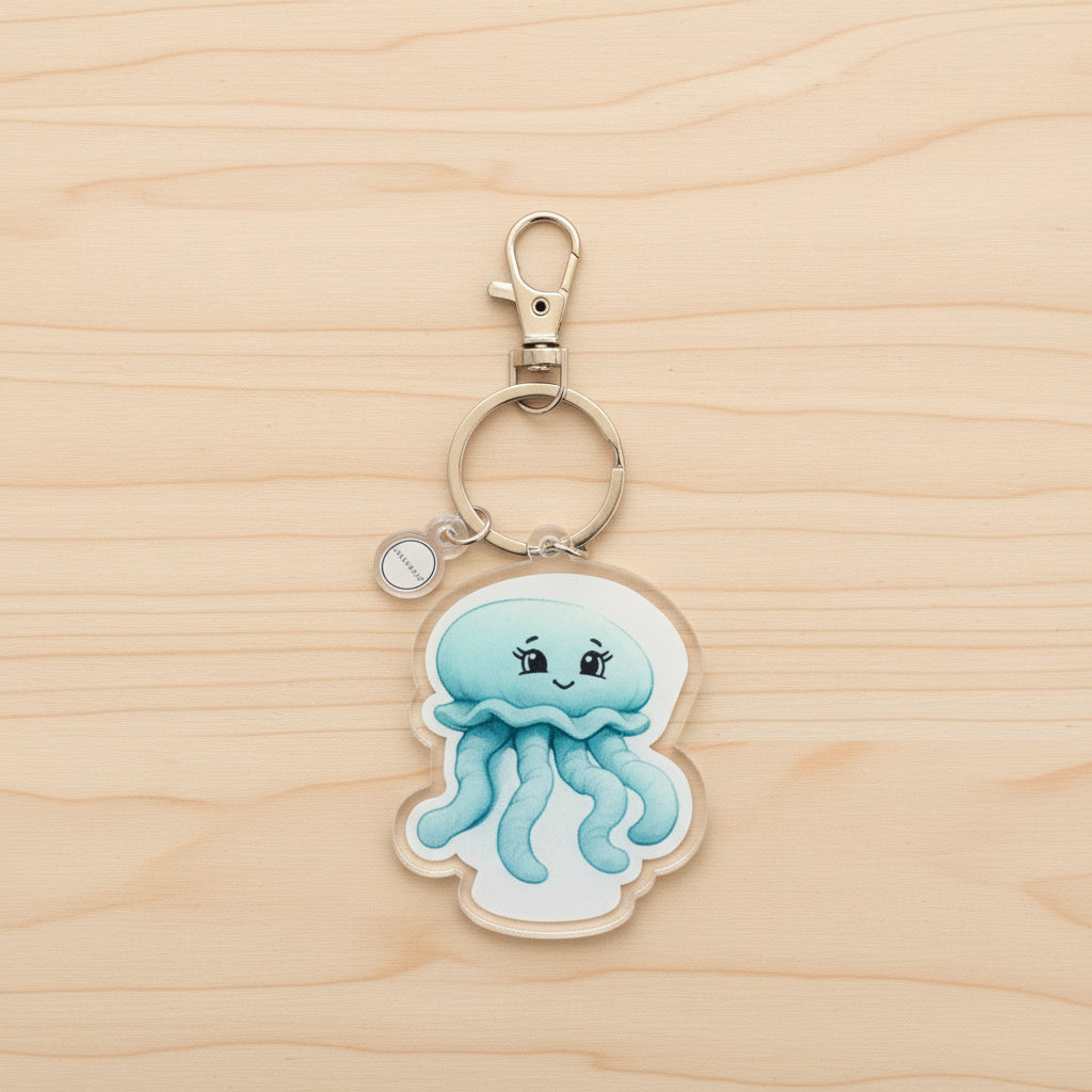 Keychain with a moon jellyfish design on a wood background