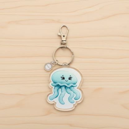 Keychain with a moon jellyfish design on a wood background